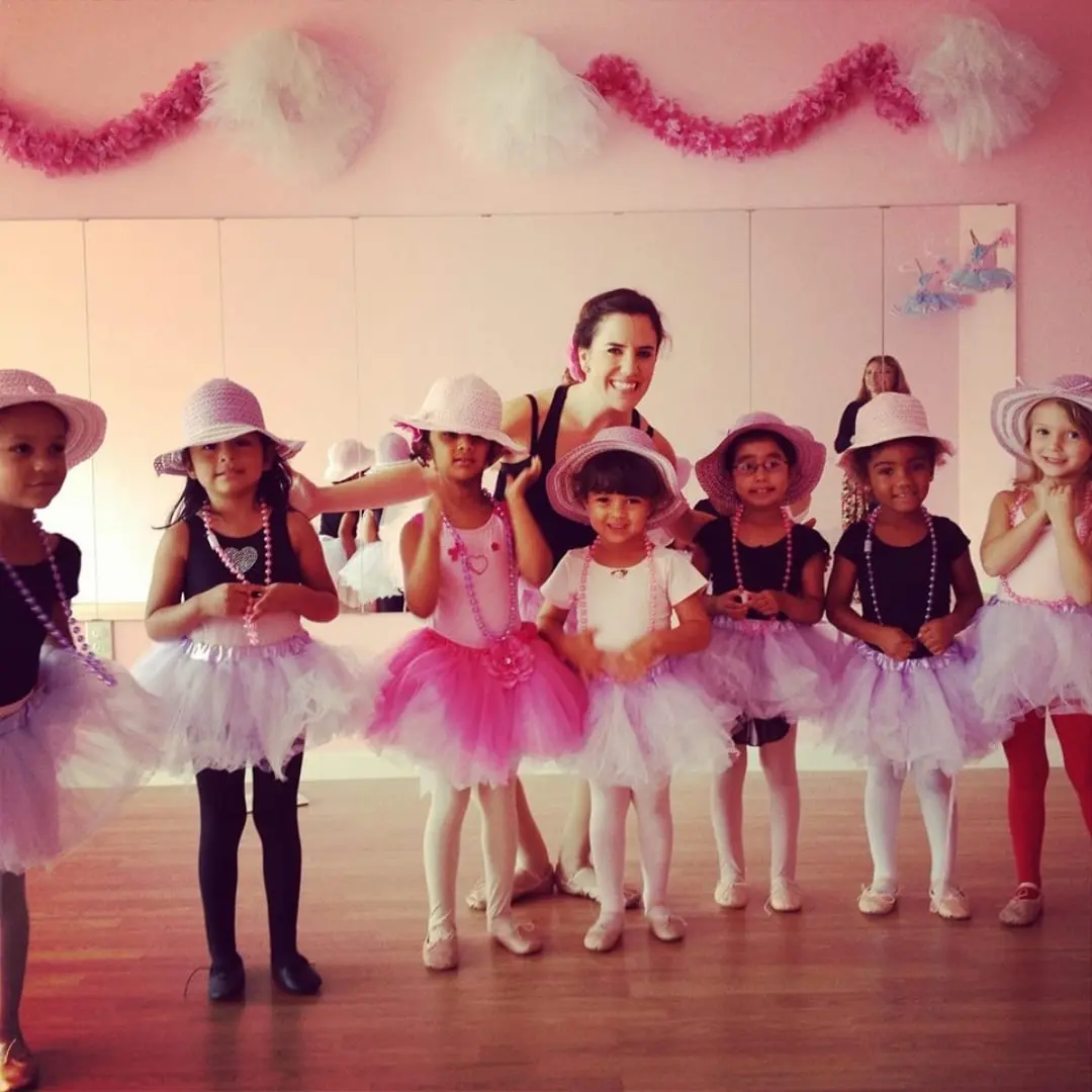 Hope with a group of young ballerinas in tutus and pink sun hats in the early days of Bella Ballet